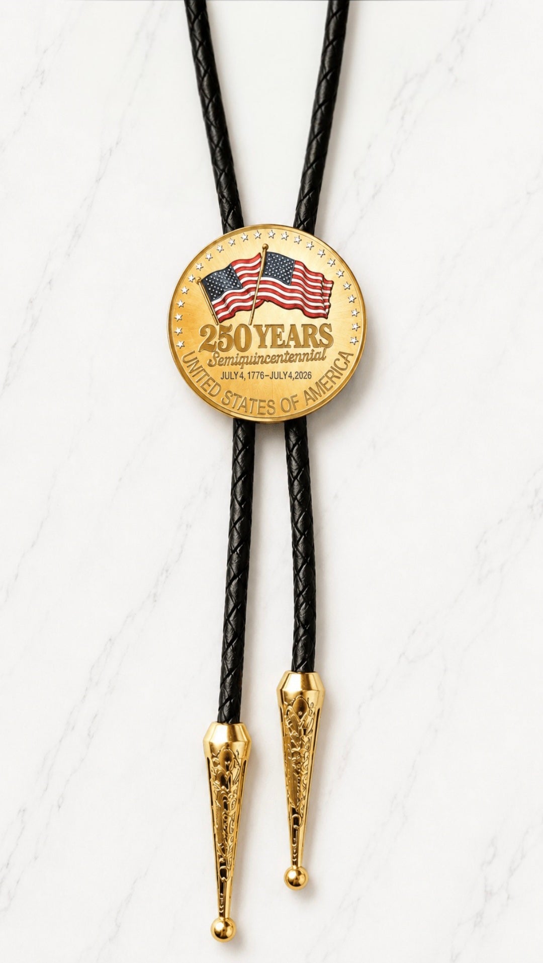 Reverse side of the 250 Years Bolo Tie featuring two American flags, 250 Years Semiquincentennial lettering, July 4 1776 to July 4 2026 dates, black braided leather, and ornate gold-tone tips on white marble