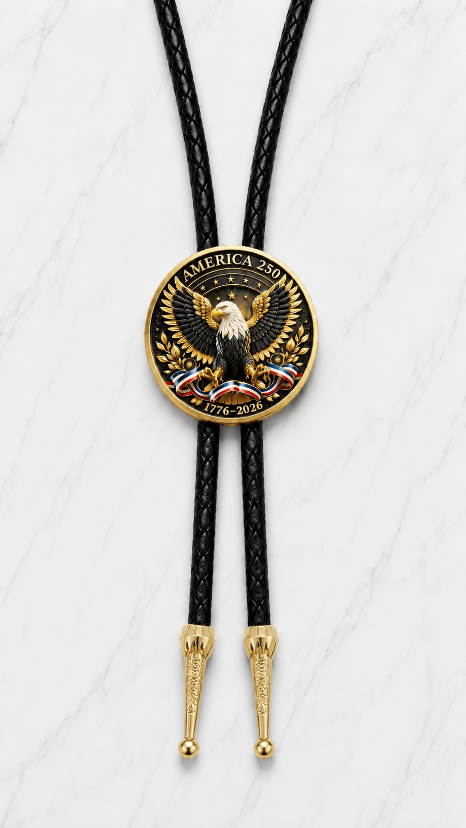  America 250 Bolo Tie Side A featuring the Statue of Liberty, United States Capitol, patriotic American flags, and the inscription "United States of America 1776–2026" mounted on premium black braided leather with polished gold engraved Western bolo tips.

