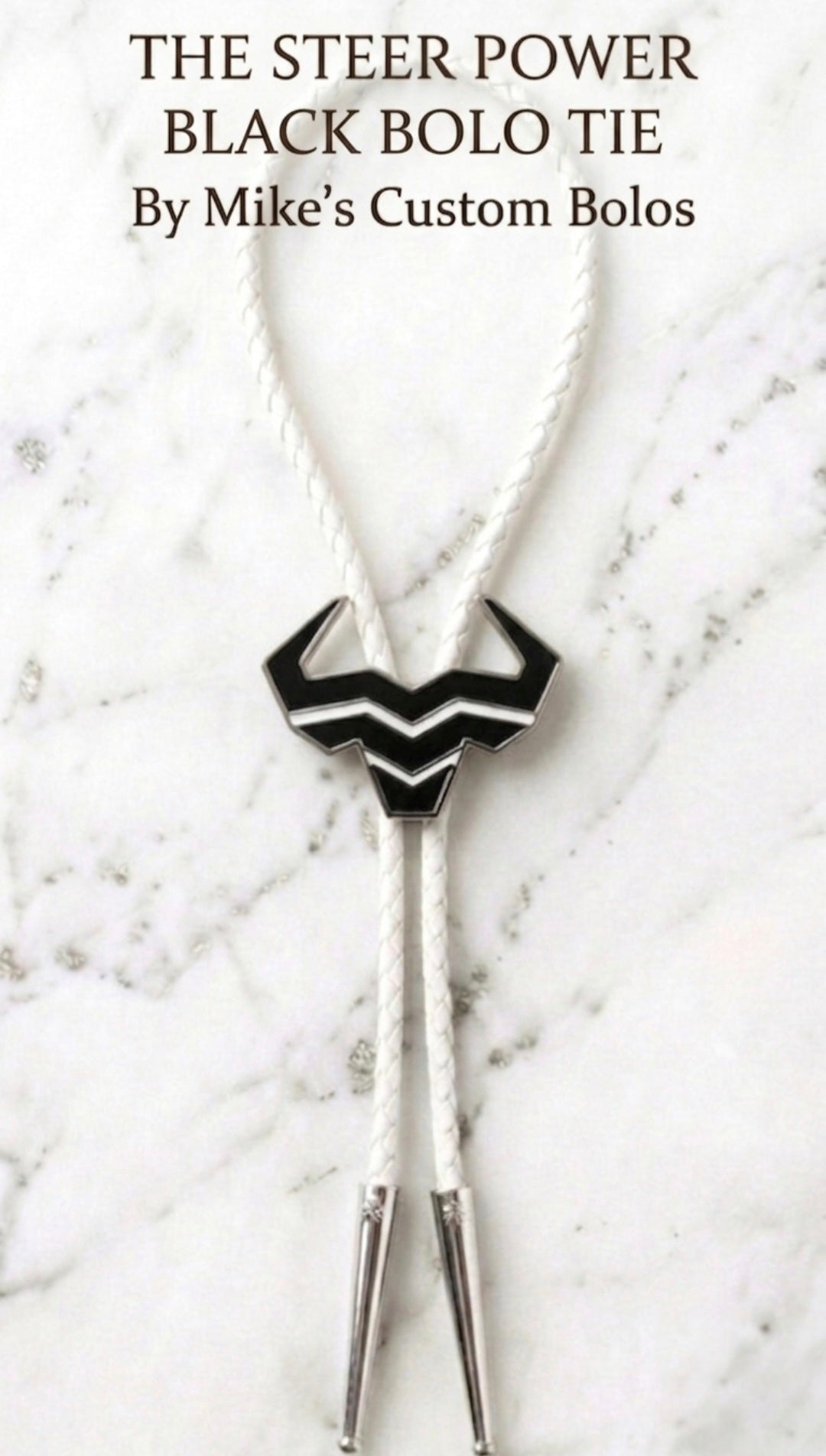Black Steer Bolo Tie by Mike's Custom Bolos featuring Steer Hat Co. black enamel steer-head centerpiece with white braided leather cord and silver tips.