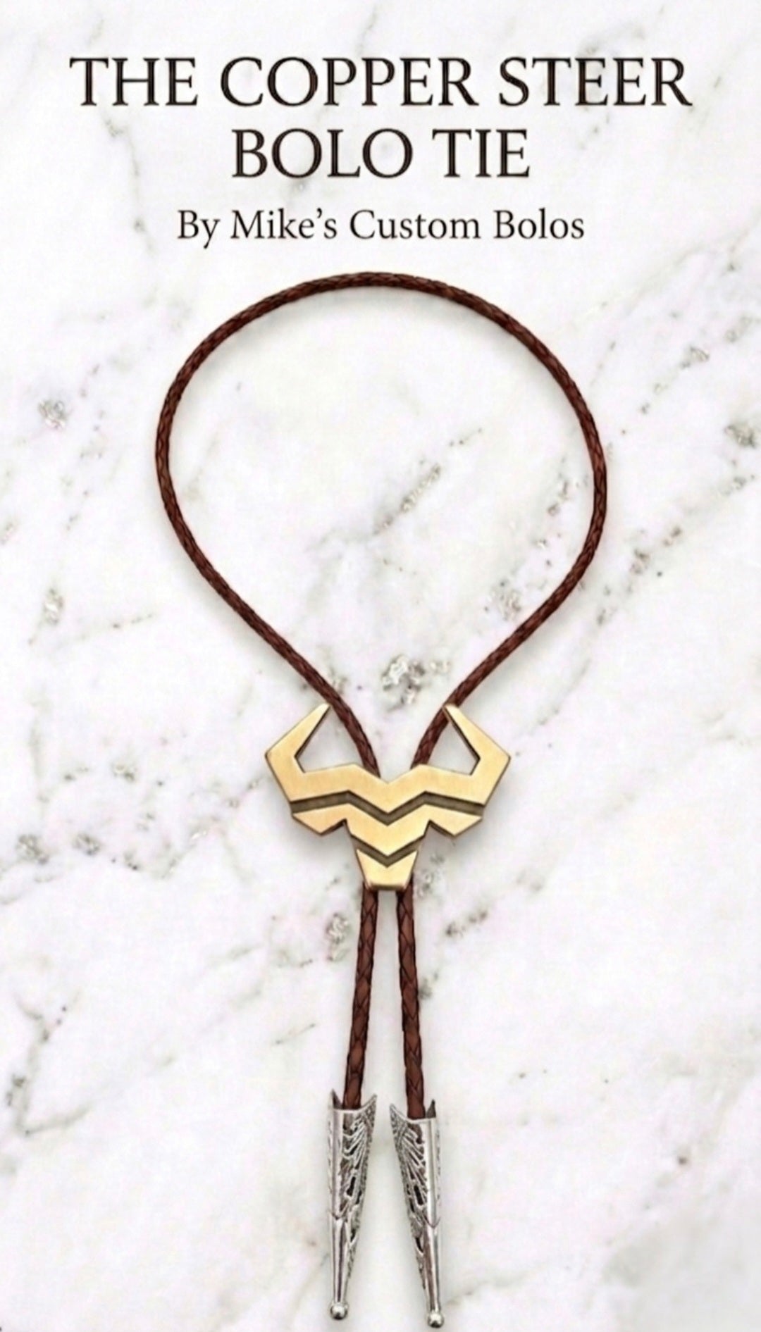Copper Steer Bolo Tie by Mike's Custom Bolos featuring Steer Hat Co. steer-head centerpiece with brown braided leather cord and engraved silver tips.