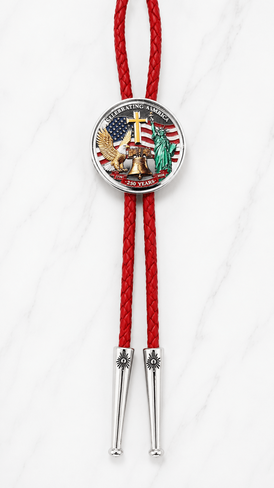 Celebrating America Bolo Tie Side A with Statue of Liberty, eagle, cross, Liberty Bell centerpiece, red braided leather, and polished silver-tone tips