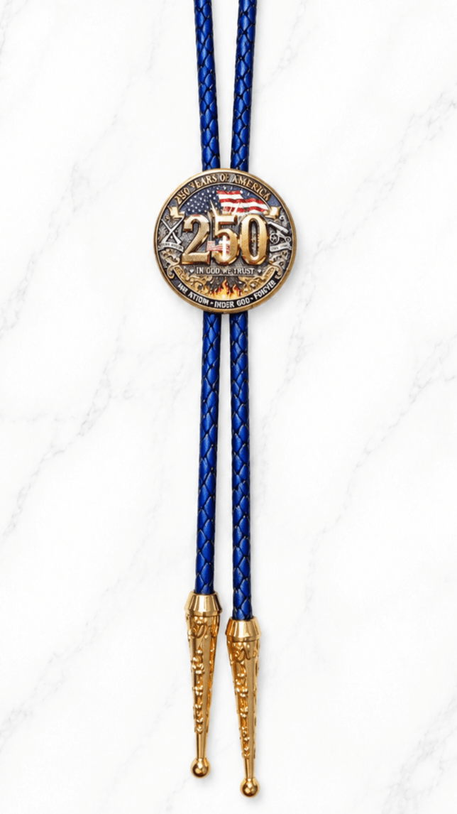 The Eagle And The Cross Bolo Tie Side A is an America 250 commemorative bolo tie featuring a collectible eagle and Cross centerpiece with navy blue braided leather and ornate gold bolo tips.
