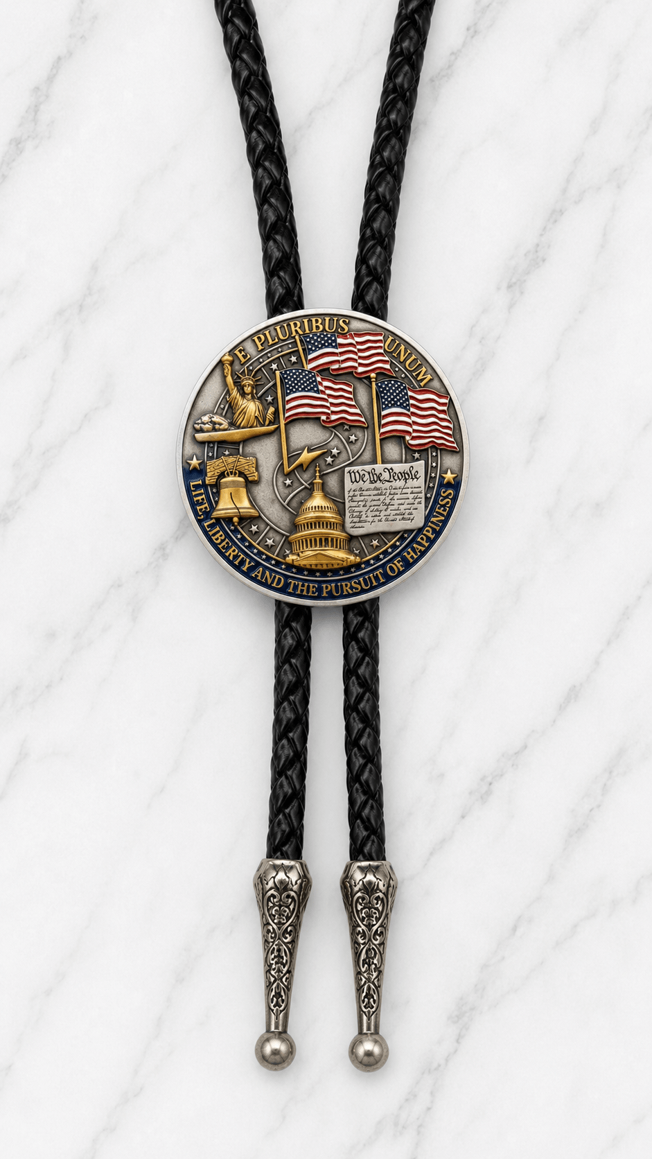 The Liberty Bell And American Eagle Bolo Tie Side B featuring American flags, the Statue of Liberty, Liberty Bell, U.S. Capitol, We the People artwork, black braided leather, and ornate antique silver-tone tips on white marble